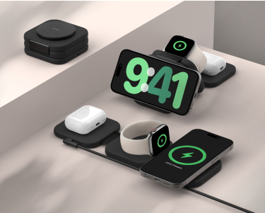 This image showcases a sleek, modular charging station designed to wirelessly charge multiple devices simultaneously. The setup includes slots for a smartphone, wireless earbuds, and a smartwatch, all shown actively charging. A compact folded version of the charging station is visible in the background, emphasizing portability. The devices are neatly arranged, highlighting the product's efficiency and modern design.