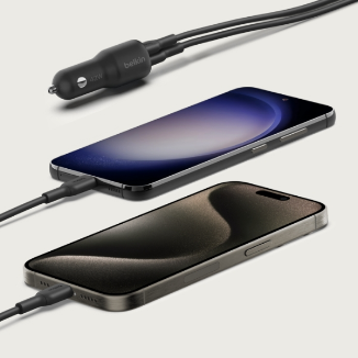 Two modern smartphones charging via USB-C cables, connected to a compact Belkin dual-port car charger.