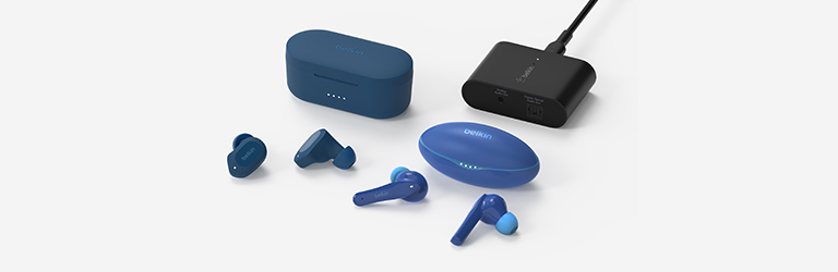 A collection of Belkin Audio products, including blue wireless earbuds and an audio adapter, displayed on a white surface.