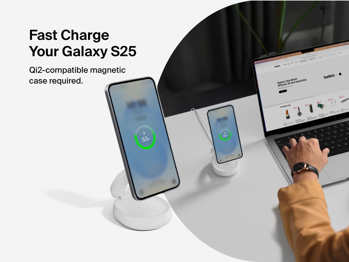 Belkin BoostCharge 2-in-1 Convertible Magnetic Charging Stand with Qi2 15W shown fast charging a Galaxy S25 in a Qi2-compatible magnetic case at a desktop workspace.
