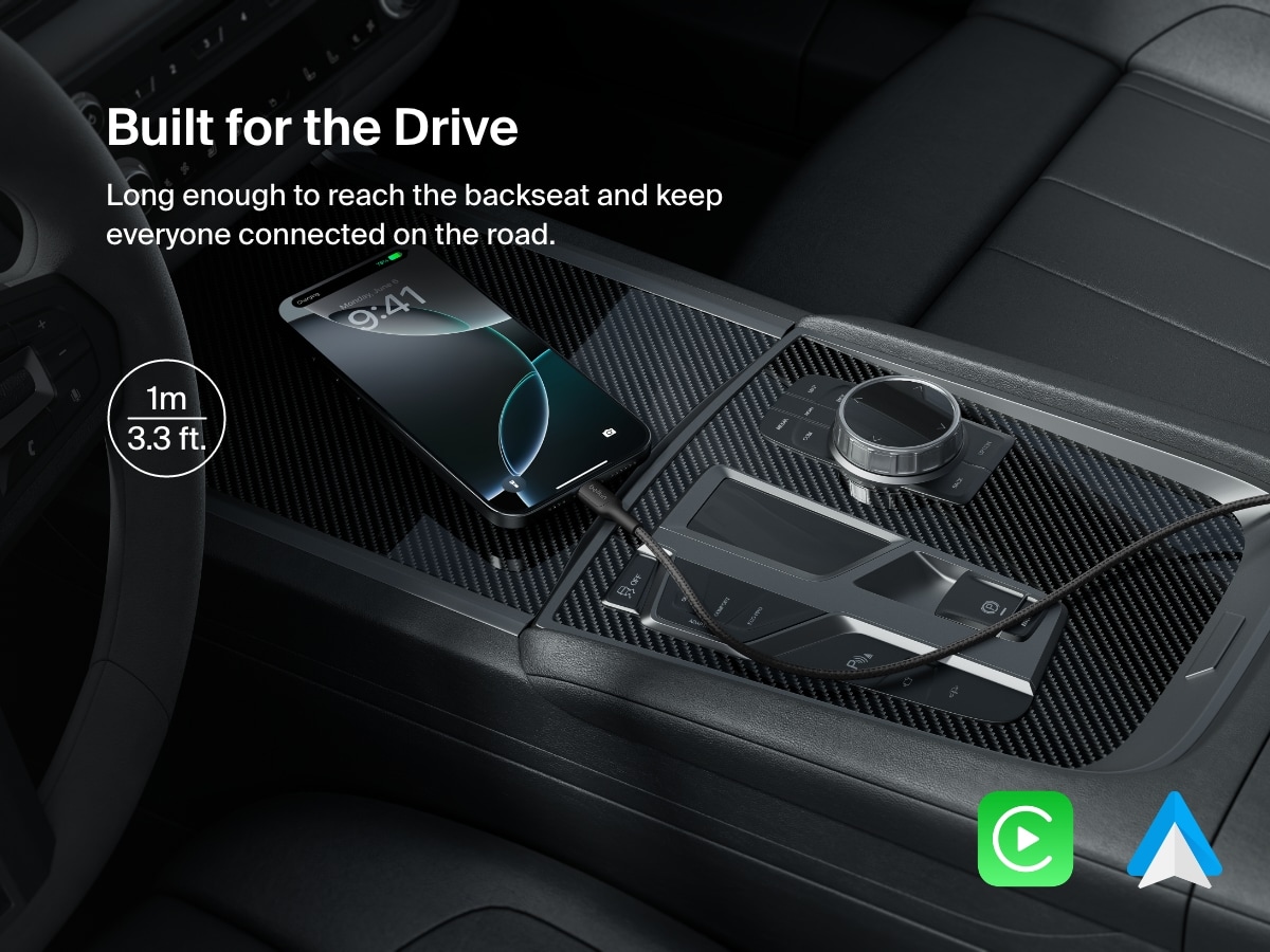 A 1-meter (3.3 ft) Belkin BoostCharge Pro Braided USB-A to USB-C Cable 15W charges a smartphone in a car, offering extended reach and seamless compatibility with Apple CarPlay and Android Auto.