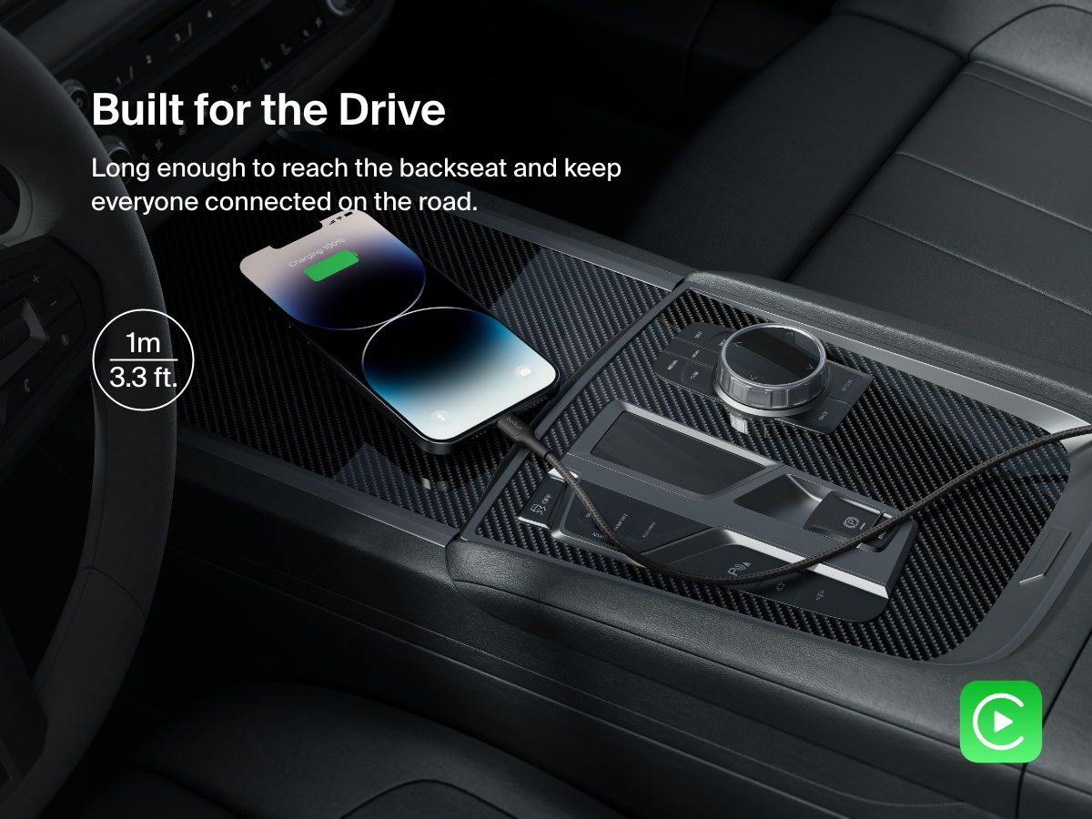 A Belkin BoostCharge Braided USB-A Cable with Lightning Connector powers an iPhone in a car, featuring a 1-meter (3.3 ft) length ideal for backseat charging and Apple CarPlay support.
