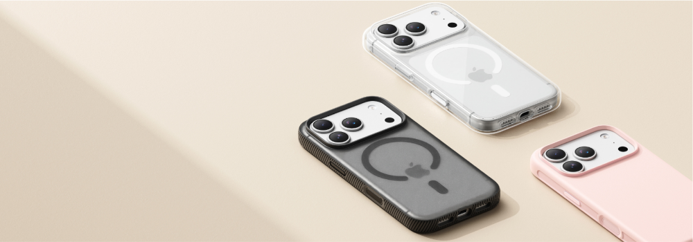 Three iPhones displayed with protective cases in different styles and colors: a clear MagSafe case, a black grip MagSafe case, and a soft pink case, all shown on a beige background.