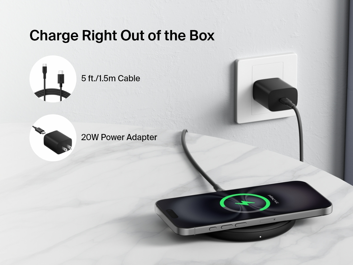 A black Belkin BoostCharge Wireless Charging Pad 15W is shown on a marble surface charging a smartphone, with text highlighting that it includes a 5 ft. (1.5m) cable and a 20W power adapter for easy setup right out of the box.