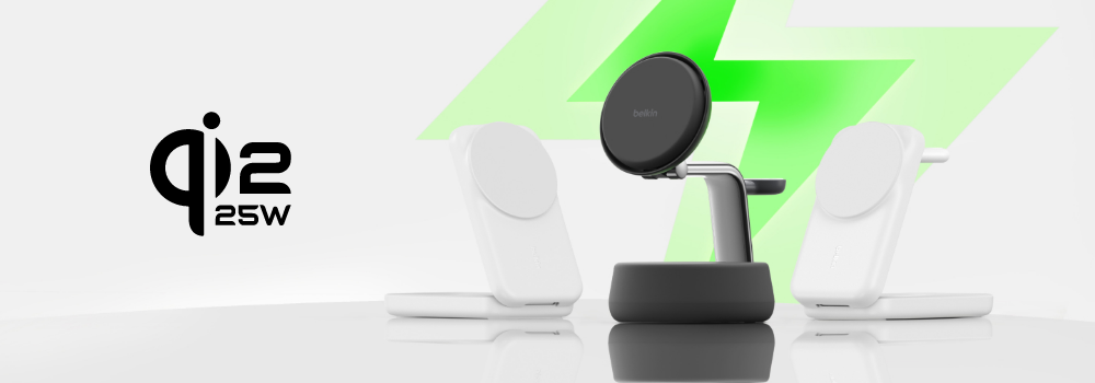 Three Belkin wireless charging stands on a reflective surface, two white models on the sides and a black model in the center, with a large green lightning bolt in the background and 'Qi2 25W' text on the left.