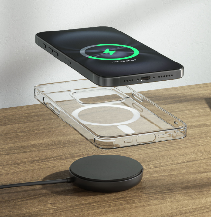 An iPhone hovers above a transparent MagSafe-compatible case, both aligned over a wireless charging pad on a wooden surface.