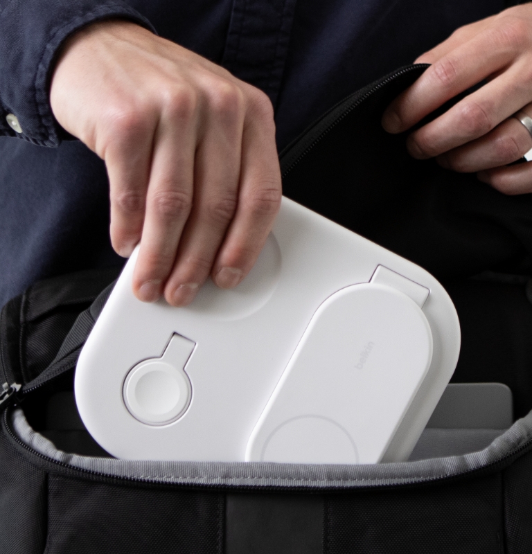Belkin 3-in-1 Magnetic Foldable Wireless Charger with Qi2 15W, folded for portability and being placed into a backpack.