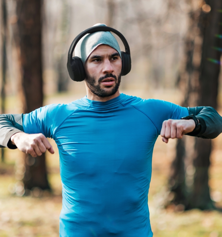 A person wearing Noise-Cancelling Over-Ear Headphones while working out.