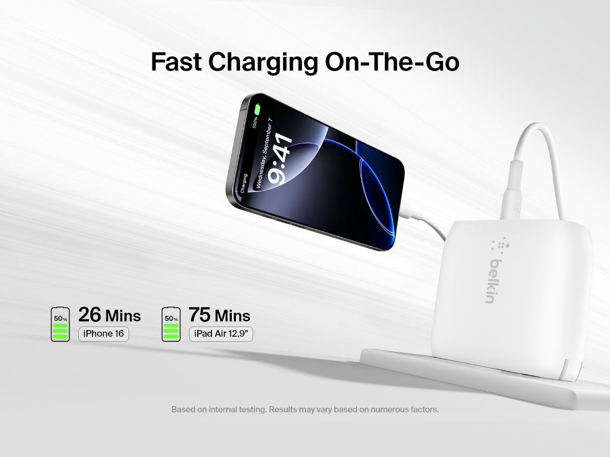 A white Belkin BoostCharge Dual USB-C PD Wall Charger 40W powers an iPhone, emphasizing fast charging on the go with visual callouts showing 50% charge in 26 minutes for iPhone 16 and 75 minutes for iPad Air 12.9″.