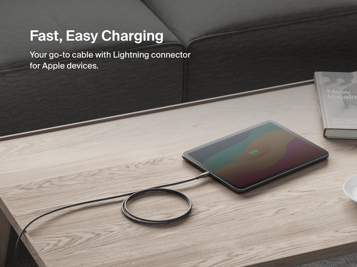 Belkin BoostCharge Pro USB-C Braided Cable with Lightning Connector shown charging an iPad on a coffee table, offering fast, reliable power for Apple devices.