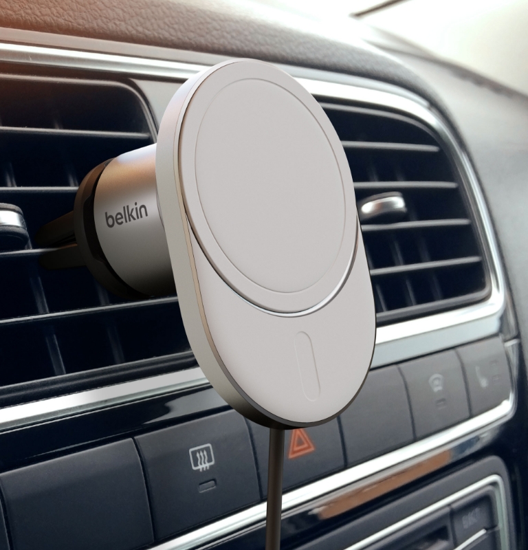 The image shows the Belkin BoostCharge Pro Magnetic Wireless Car Charger with Qi2 15W mounted on a car's air vent, highlighting its secure attachment and sleek design.