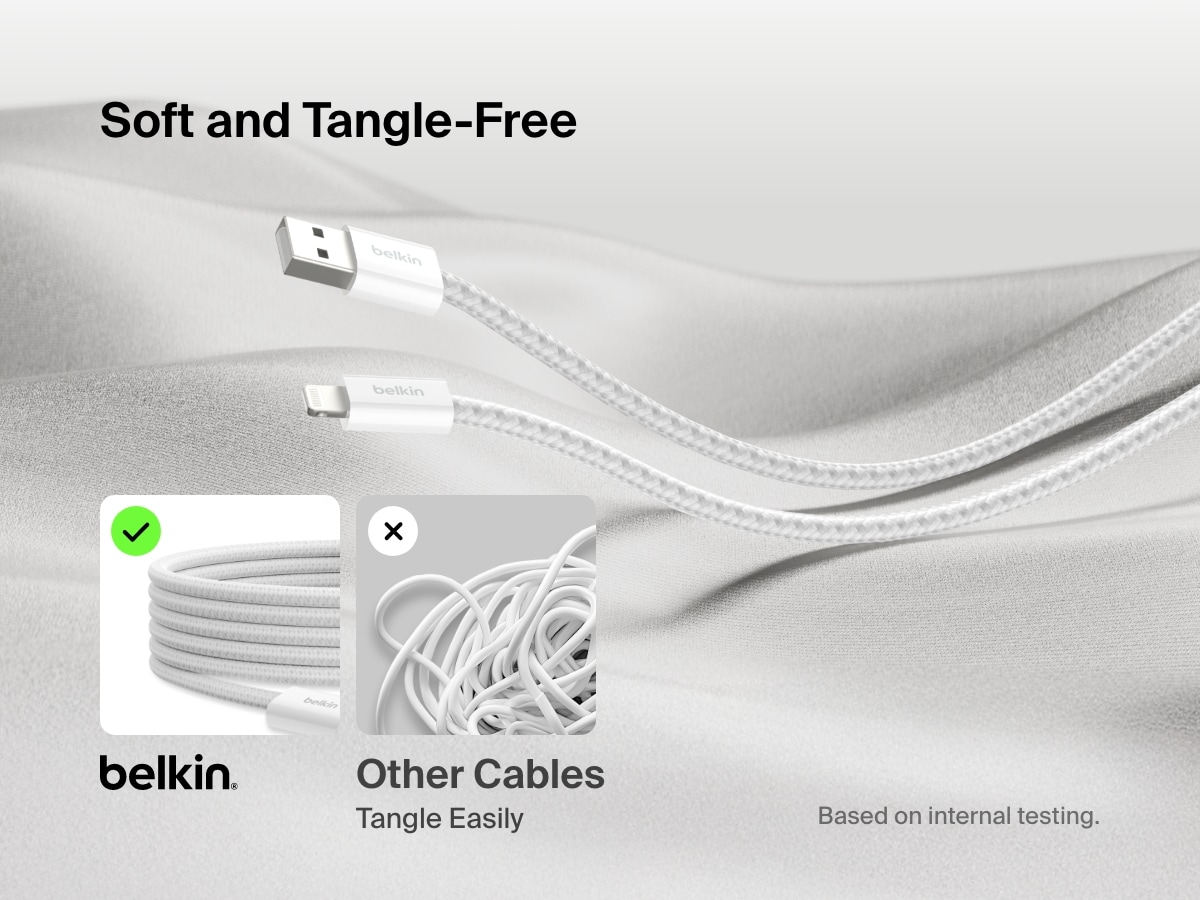 Belkin BoostCharge USB-A Cable with Lightning Connector shown on soft fabric, highlighting its ultra-flexible, tangle-free braided design compared to easily tangled standard cables.